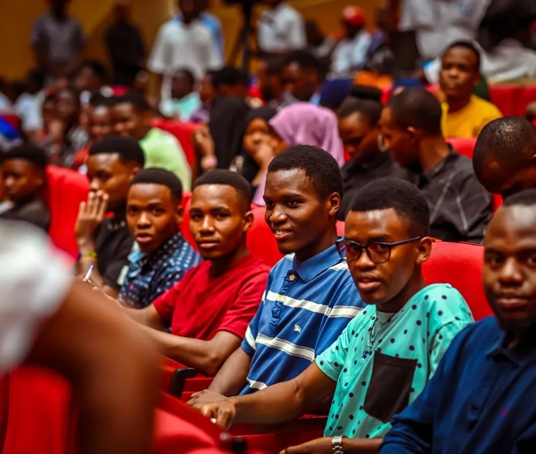Young people seated in the audience of an event